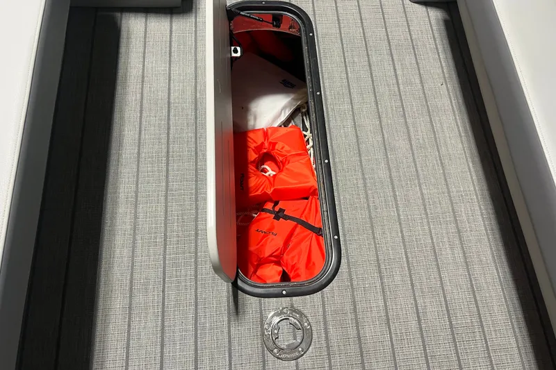 Slide: The Image of Storage compartment on Veranda VR 265 VL boat, containing bright orange life jackets. - 4