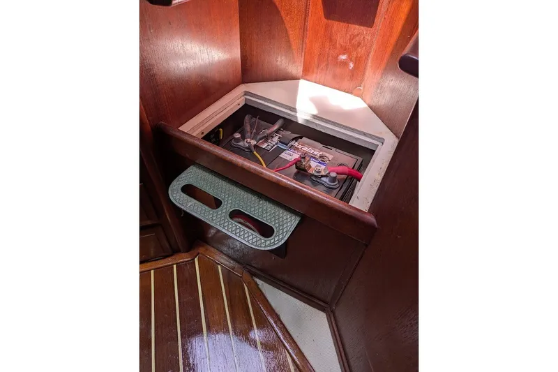 Slide: The Image of Battery compartment in 1988 Ericson 38-200 sailboat with wooden interior. - 45