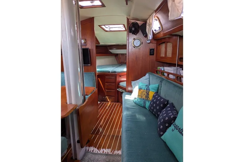 Slide: The Image of Interior of 1988 Ericson 38-200 sailboat with cozy seating and wooden accents. - 39