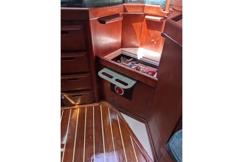 Slide: The Image of Interior of 1988 Ericson 38-200 sailboat with wooden cabinetry and storage compartment. - 44