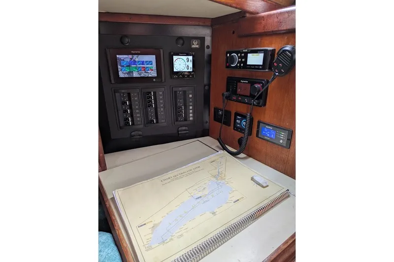 Slide: The Image of Navigation station of a 1988 Ericson 38-200 sailboat with electronic equipment and nautical chart. - 17