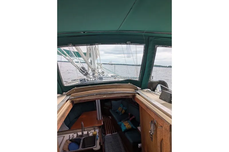 Slide: The Image of Interior view of 1988 Ericson 38-200 sailboat with green canopy and cozy cabin. - 14