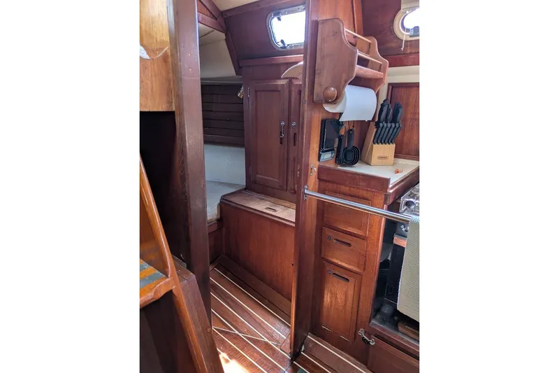 Slide: The Image of Interior of 1988 Ericson 38-200 sailboat with wooden cabinetry and kitchen area. - 34