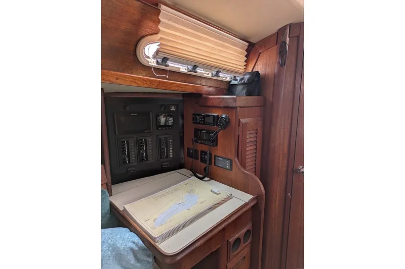 Slide: The Image of Navigation station inside 1988 Ericson 38-200 sailboat with chart and control panel. - 22