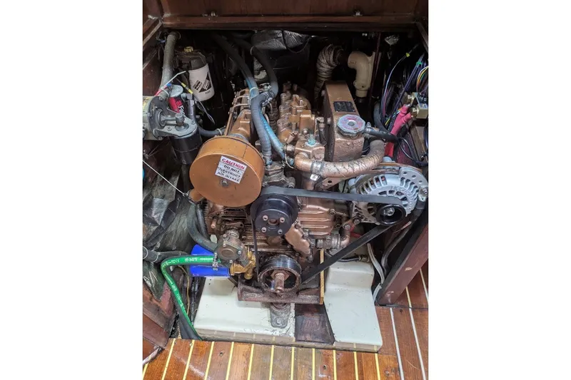 Slide: The Image of Engine compartment of a 1988 Ericson 38-200 sailboat, showcasing mechanical components and wiring. - 49
