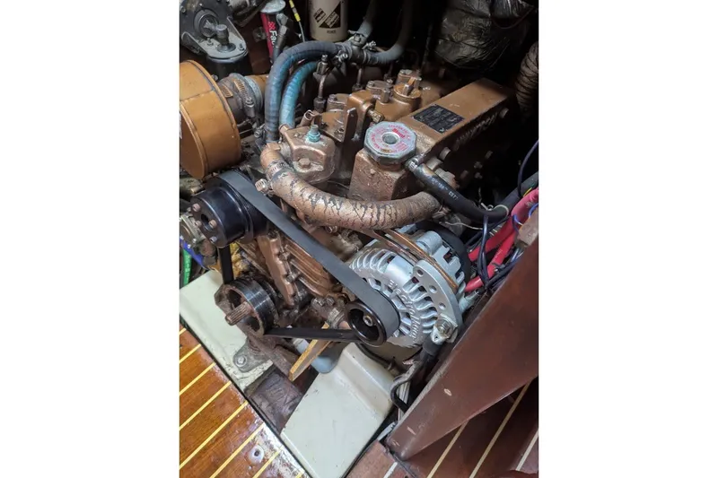 Slide: The Image of Engine of a 1988 Ericson 38-200 sailboat, showcasing mechanical components and belts. - 50