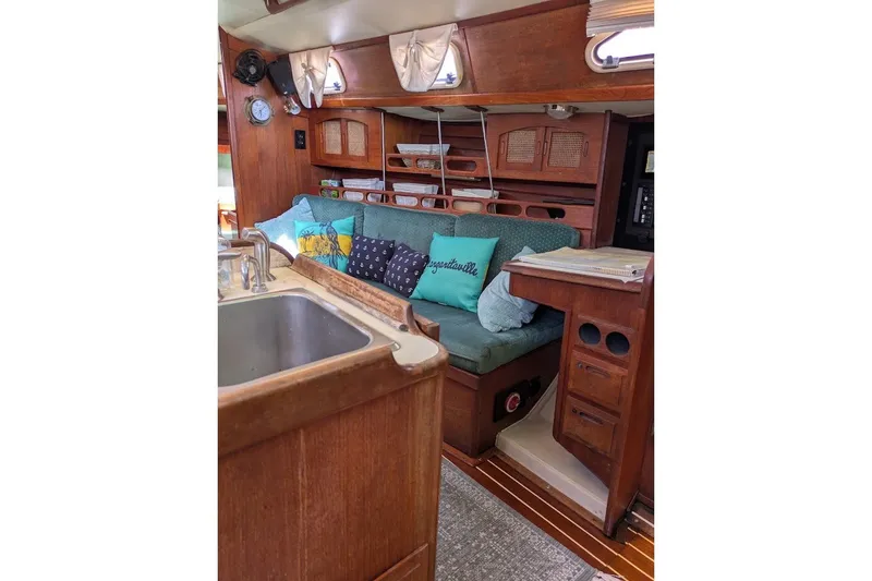 Slide: The Image of Interior of 1988 Ericson 38-200 sailboat with cozy seating and wooden cabinetry. - 37