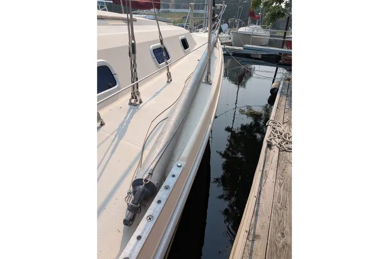Slide: The Image of 1988 Ericson 38-200 sailboat docked, showing deck and rigging details. - 32