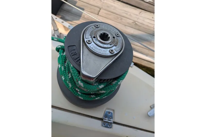 Slide: The Image of Winch on 1988 Ericson 38-200 sailboat with green rope, dock background. - 28