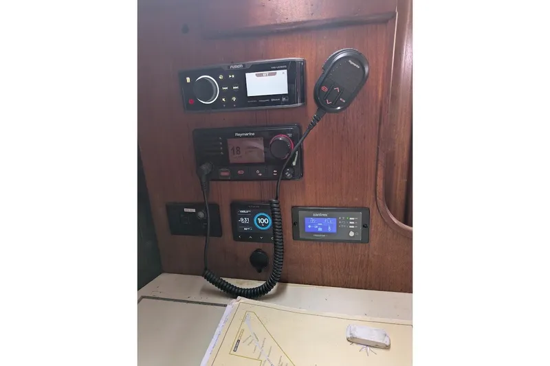 Slide: The Image of Control panel of a 1988 Ericson 38-200 sailboat with navigation and communication equipment. - 18
