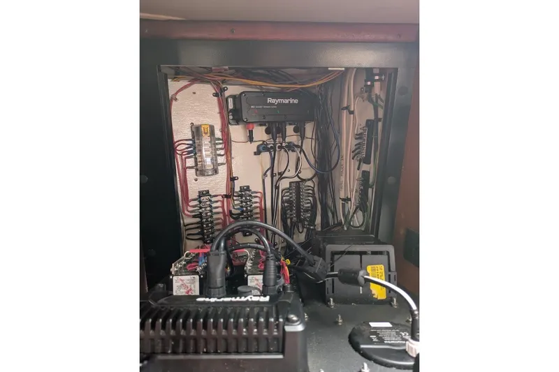 Slide: The Image of Electrical panel inside 1988 Ericson 38-200 sailboat, featuring Raymarine equipment and wiring. - 20