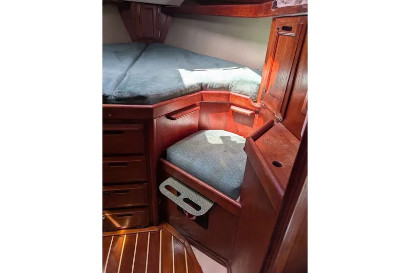 Slide: The Image of Interior of 1988 Ericson 38-200 sailboat with wooden cabinetry and cushioned seating. - 42