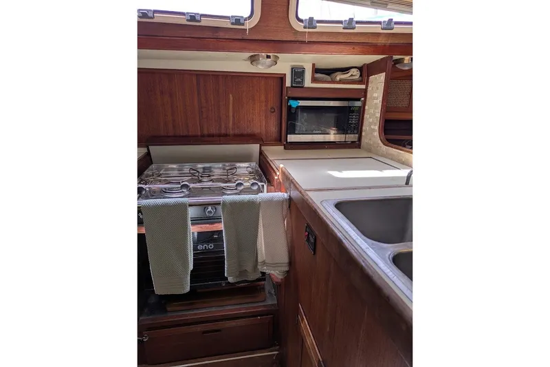 Slide: The Image of 1988 Ericson 38-200 yacht kitchen with stove, microwave, and sink. - 35