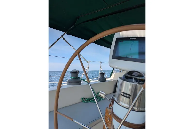 Slide: The Image of Cockpit view of 1988 Ericson 38-200 sailboat with navigation equipment and ocean backdrop. - 15