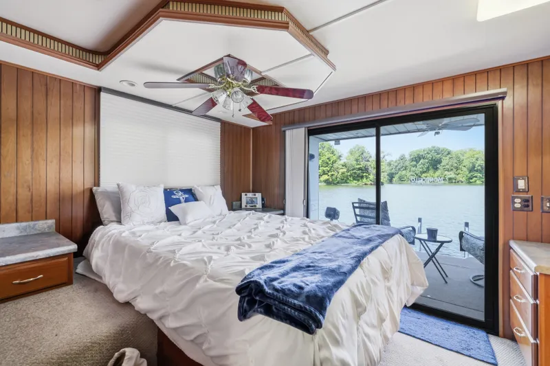 Slide: The Image of Luxurious Monticello 16x70 houseboat bedroom with lake view, featuring cozy bed and elegant decor. - 56