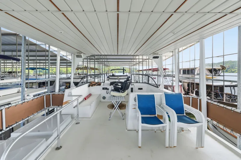 Slide: The Image of Upper deck of a 2002 Monticello 16x70 houseboat with seating and helm station. - 16