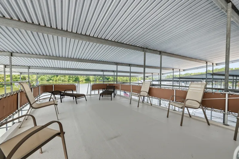 Slide: The Image of Spacious upper deck of 2002 Monticello 16x70 houseboat with lounge chairs and scenic lake view. - 22