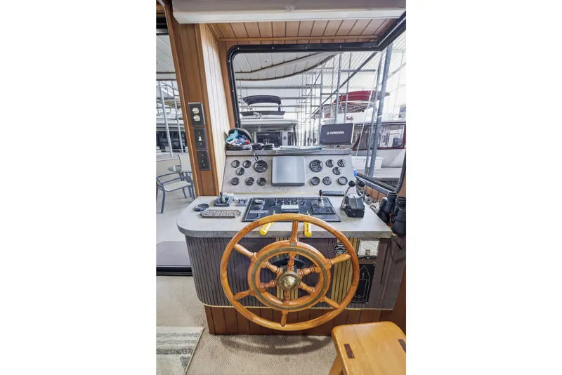 Slide: The Image of Control panel of a 2002 Monticello 16x70 boat with wooden steering wheel. - 26