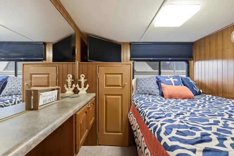 Slide: The Image of Cozy bedroom in 2002 Monticello 16x70 houseboat with nautical decor and wood paneling. - 39