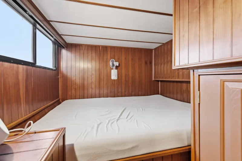 Slide: The Image of Cozy wooden cabin bedroom in 2002 Monticello 16x70 houseboat with window and fan. - 54
