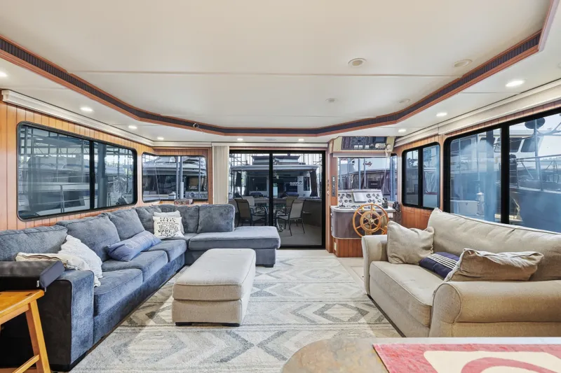 Slide: The Image of Luxurious interior of a 2002 Monticello 16x70 houseboat with plush seating and helm station. - 31