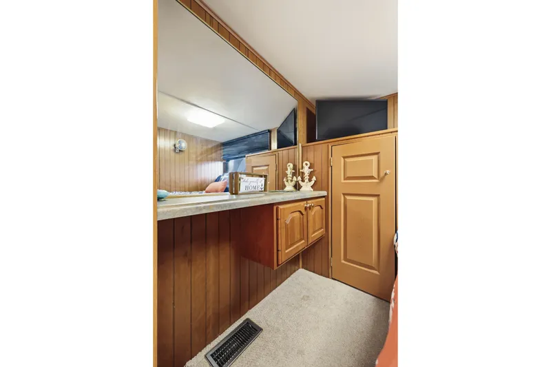 Slide: The Image of Interior of 2002 Monticello 16x70 houseboat with wood paneling and decorative accents. - 41