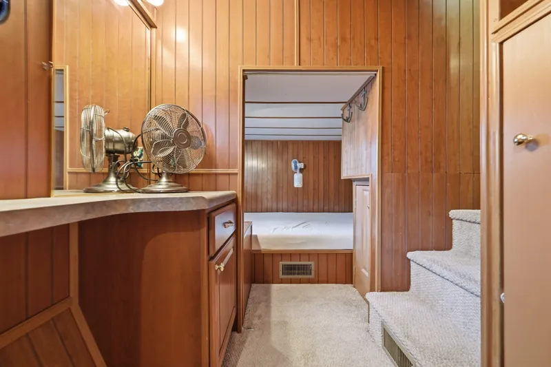 Slide: The Image of Cozy wooden interior of 2002 Monticello 16x70 with fans and carpeted stairs. - 53