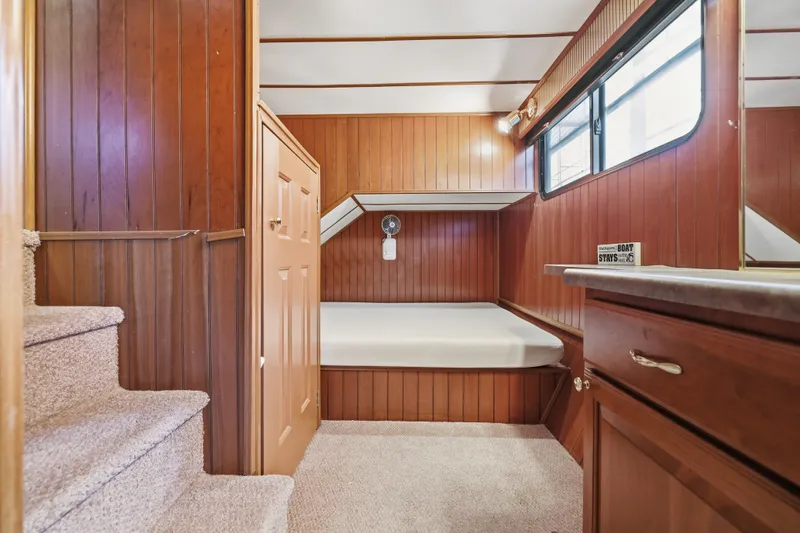 Slide: The Image of Interior of 2002 Monticello 16x70 houseboat with wood paneling and cozy sleeping area. - 50