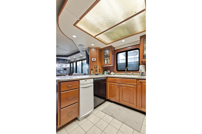 Slide: The Image of Luxurious kitchen interior of 2002 Monticello 16x70 houseboat with wooden cabinets and modern appliances. - 38