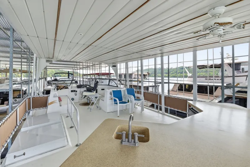 Slide: The Image of Spacious interior of a 2002 Monticello 16x70 houseboat with seating and kitchen area. - 15