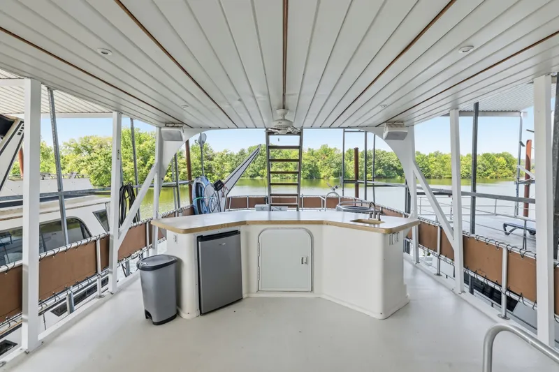 Slide: The Image of Spacious deck of 2002 Monticello 16x70 houseboat with outdoor kitchen and scenic lake view. - 19