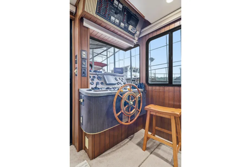 Slide: The Image of Pilothouse interior of 2002 Monticello 16x70 with wooden steering wheel and control panel. - 29