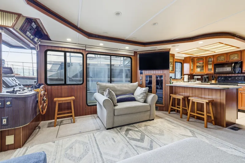 Slide: The Image of Luxurious 2002 Monticello 16x70 houseboat interior with cozy seating, kitchen, and helm station. - 25