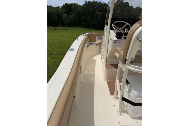 Slide: The Image of 2020 Scout 235 XSF boat interior with beige seating and steering console. - 16