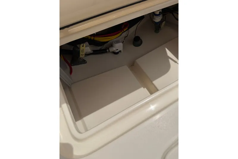 Slide: The Image of 2020 Scout 235 XSF boat compartment with wiring and components visible. - 14