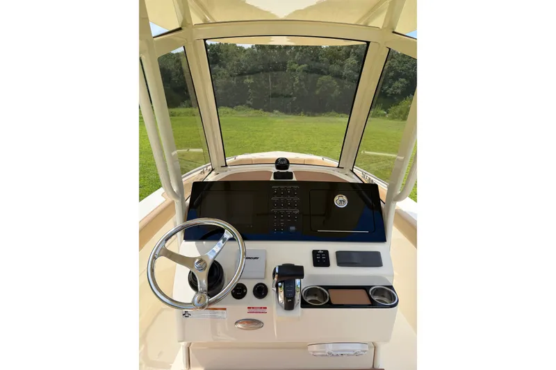 Slide: The Image of 2020 Scout 235 XSF boat helm with steering wheel and control panel. - 13