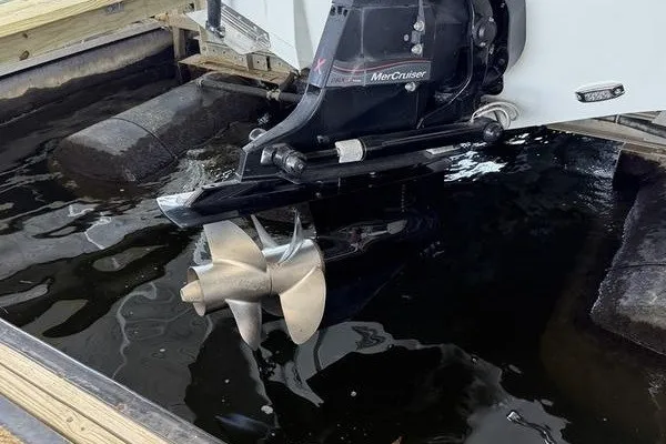 Slide: The Image of 2024 Crownline 290 SS boat with MerCruiser engine and propeller in water. - 13