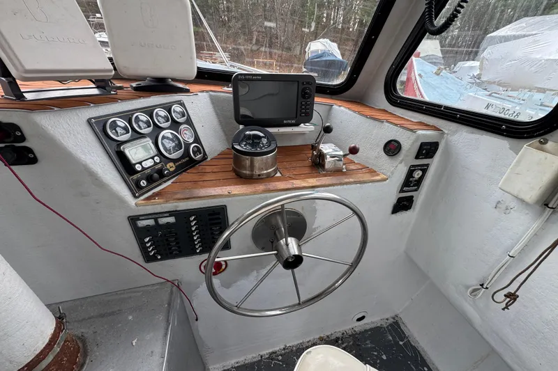 Slide: The Image of Helm of 2007 Northern Bay 36 boat with navigation instruments and steering wheel. - 18