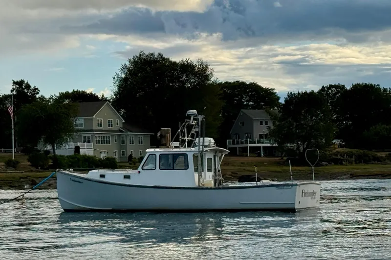 Slide: The Image of 2007 Northern Bay 36 boat on calm water near residential shoreline. - 1