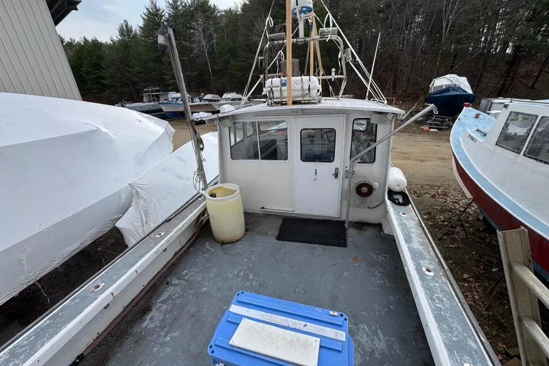 Slide: The Image of 2007 Northern Bay 36 boat docked, surrounded by other vessels and trees in the background. - 12