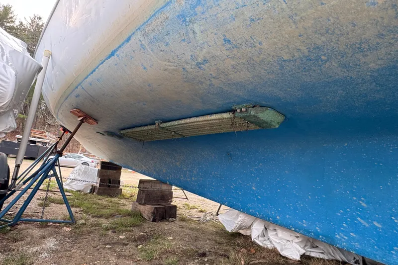 Slide: The Image of 2007 Northern Bay 36 boat hull on stands, showing underside details and marine growth. - 10
