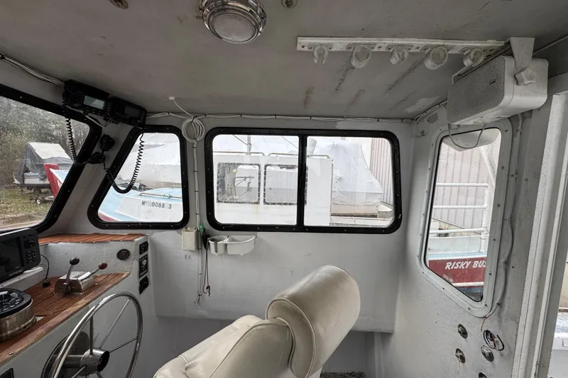 Slide: The Image of Interior of a 2007 Northern Bay 36 boat, featuring steering wheel and navigation equipment. - 25