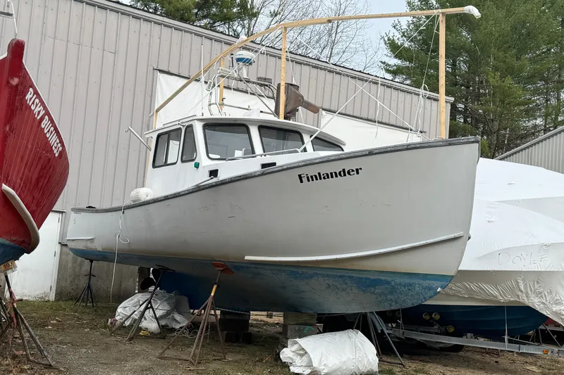Slide: The Image of 2007 Northern Bay 36 boat named "Finlander" in dry dock, alongside other vessels. - 3