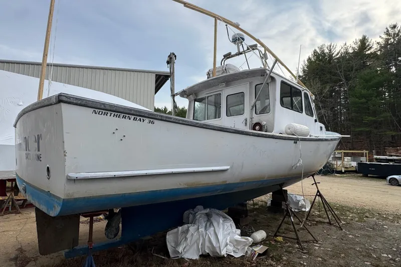 Slide: The Image of 2007 Northern Bay 36 boat on dry dock, surrounded by trees and equipment. - 5