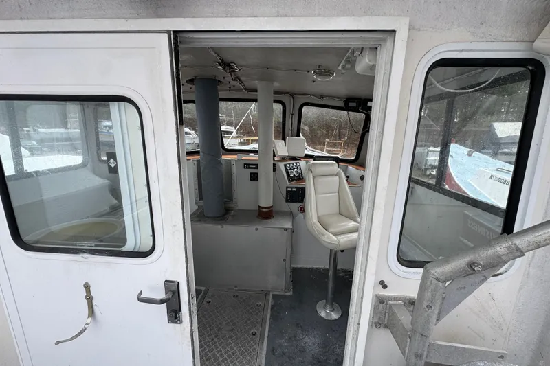 Slide: The Image of Interior view of a 2007 Northern Bay 36 boat, featuring a helm station and seating. - 14