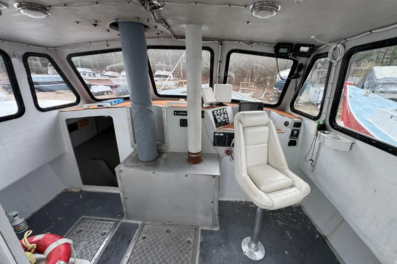 Slide: The Image of Interior of a 2007 Northern Bay 36 boat, featuring helm and seating area. - 17