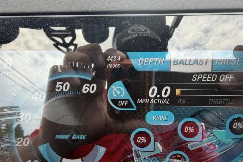 Slide: The Image of Dashboard of a 2016 Malibu Wakesetter 25 LSV showing speed and settings. - 2