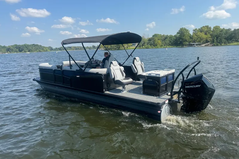 Slide: The Image of 2027 Premier 250 Sunsation pontoon boat cruising on a lake under a clear sky. - 3