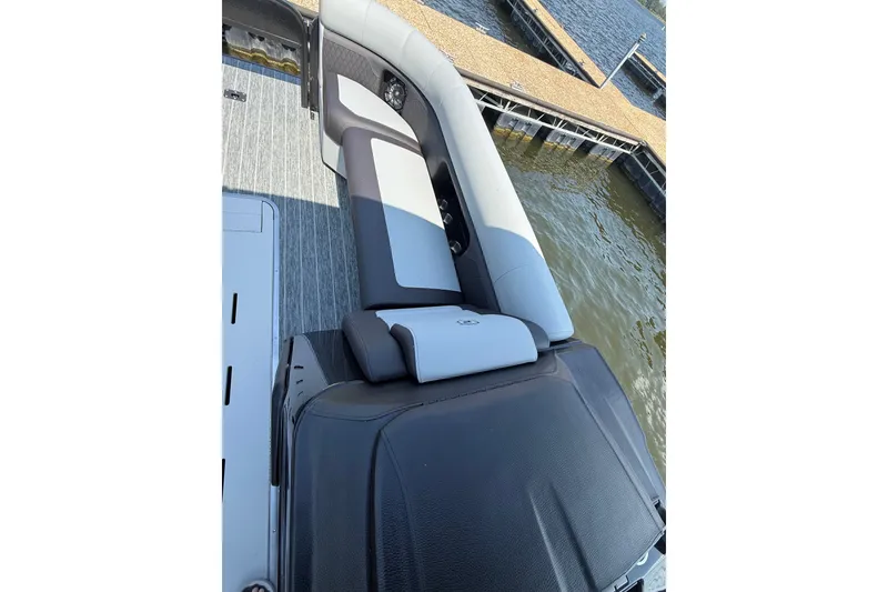 Slide: The Image of 2027 Premier 250 Sunsation boat interior with sleek seating and dockside view. - 7