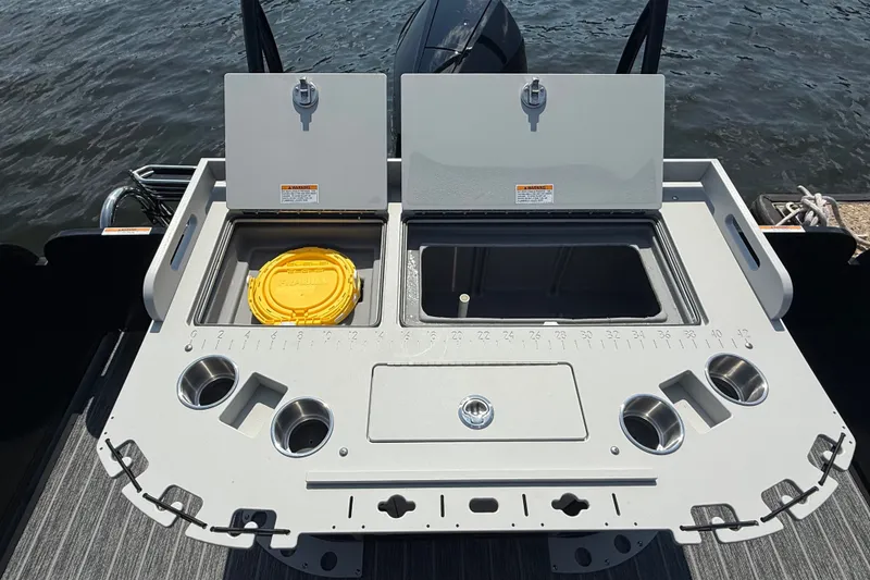 Slide: The Image of Premier 250 Sunsation 2027 boat deck with storage compartments and cup holders on water. - 11